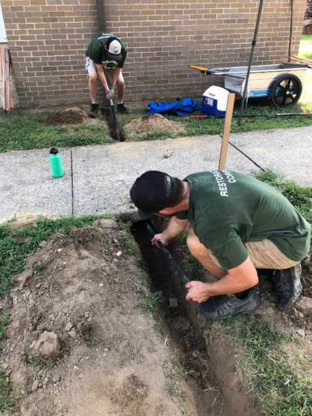 digging a trench for a pipe to rain garden at indian avenue school
