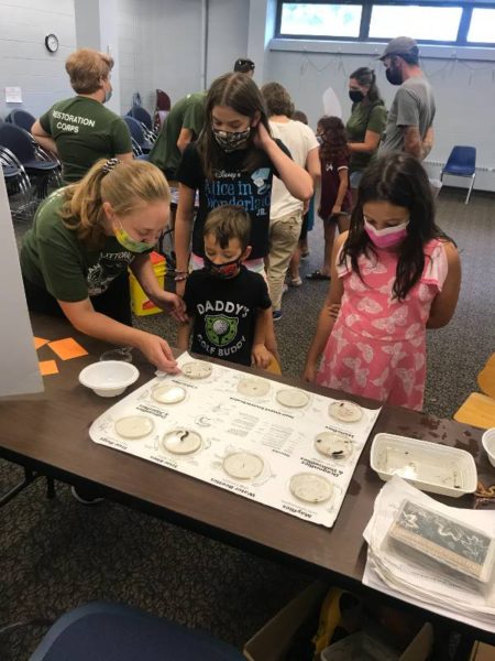sophia teaching kids about benthic macroinvertebrates